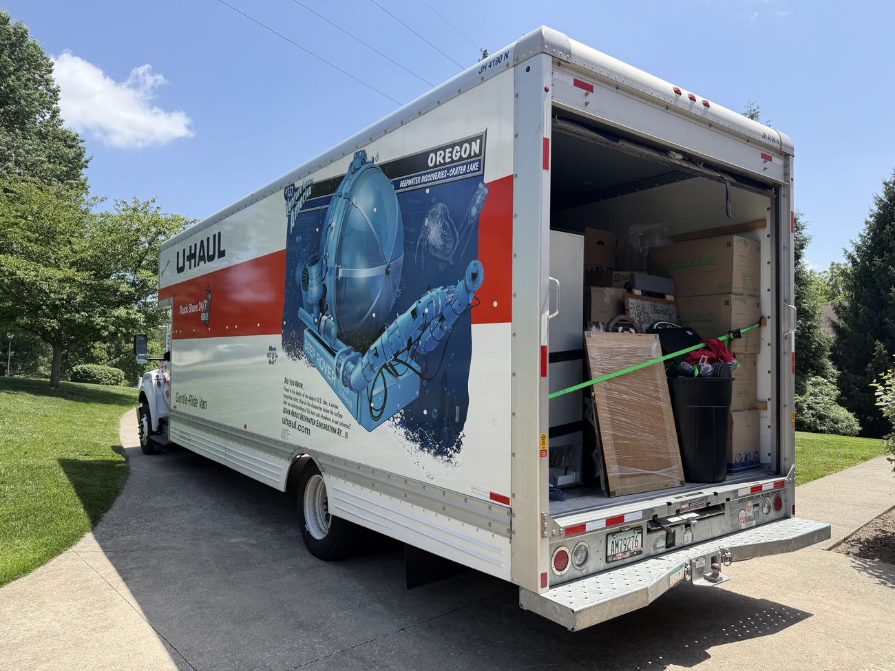 A box truck loaded with furniture and boxes on the way out of a job.